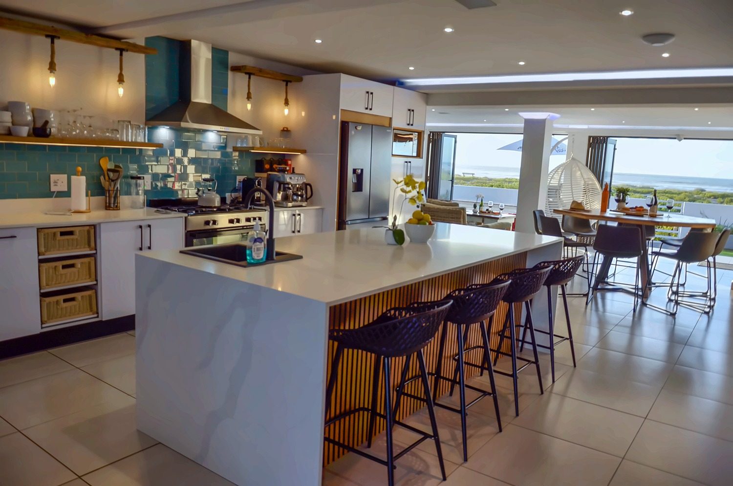 Rooisee's kitchen with open doors looking out to the sea